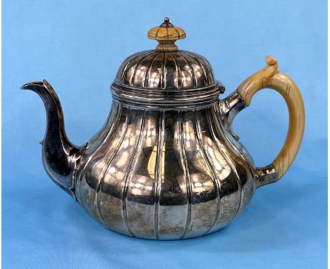 A Victorian hallmarked silver teapot of fluted baluster form, London 1871, 22.5oz by Garrards (presentation inscription to ba