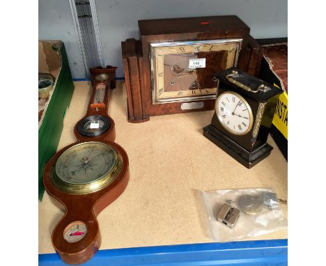 An Art Deco walnut ebonized Edwardian chiming mantle clock. 