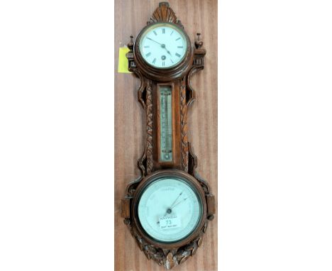 An Edwardian clock/barometer with thermometer in carved oak wall hanging case.&nbsp;&nbsp;Both the clock and barometer requir