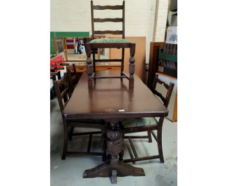 A Jacobean style oak dining suite comprising rectangular table and 4 ladder back chairs 