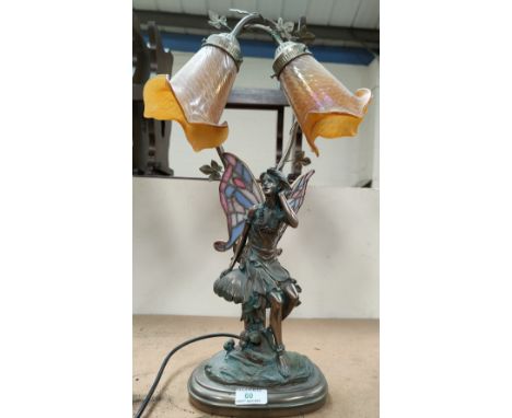 A bronzed effect table  lamp depicting a fairy sat on a mushroom with Tiffany style wings, trio lustre shades, height 60 cm 