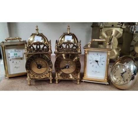 Two reproduction lantern clocks and 2 reproduction carriage clocks with battery movements; an 'egg' clock, heights 12 - 17.5 