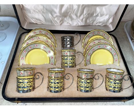 A cased set of 6 Aynsley coffee cups and saucers in pierced hallmarked silver holders, Sheffield 1920 (1 cup missing)Five pla