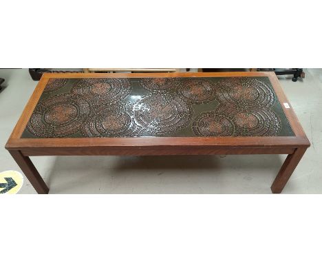 A 1960's rectangular coffee table with walnut framed ceramic top in the style of Poole 