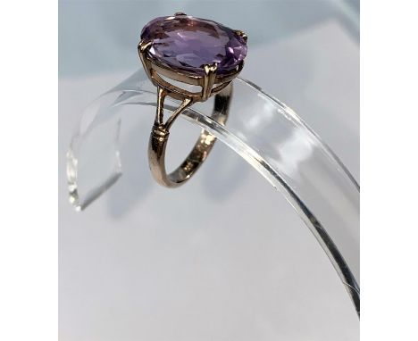 A 9 carat gold dress ring set large amethyst coloured stone, 4.8 gm. size R.5 