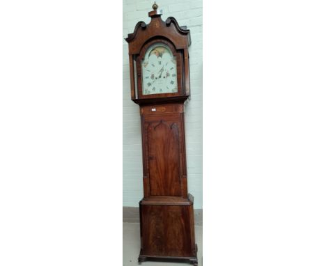 An early 19th Century mahogany long case clock with extensive Sheraton style inlaid decoration, the hood with swan neck pedim