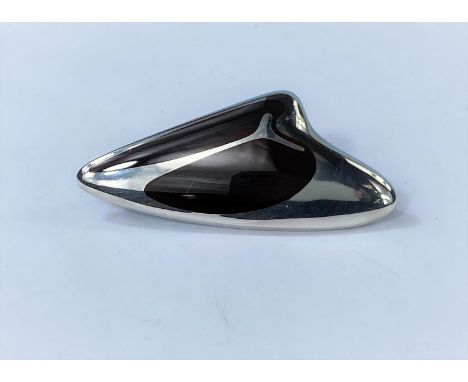 Georg Jensen, a silver brooch of abstract design by Henning Koppel, with black enamel decoration, stamped "Georg Jensen in be