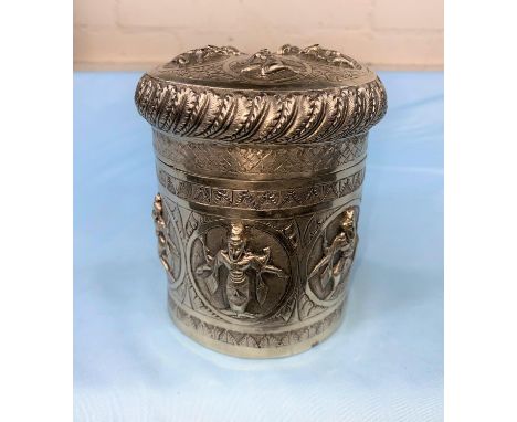 A 19th century Indian silver cylindrical tea caddy with compressed cover, engraved and repousse decoration with figures, impr