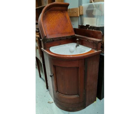 A mid Victorian pitch pine Butler's Panmtry corner fitting cupboard with bow front, marbled ceramic wash basin to the interio