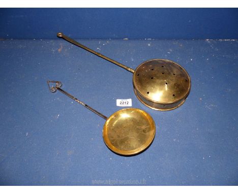 A brass chestnut roaster and shallow ladle.
