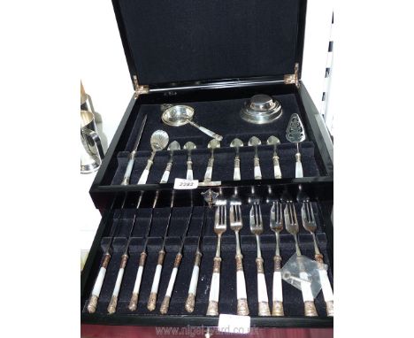 A black canteen of Cutlery containing mother of pearl handled dessert set, tea strainer, knives &amp; forks, cake knife, suga