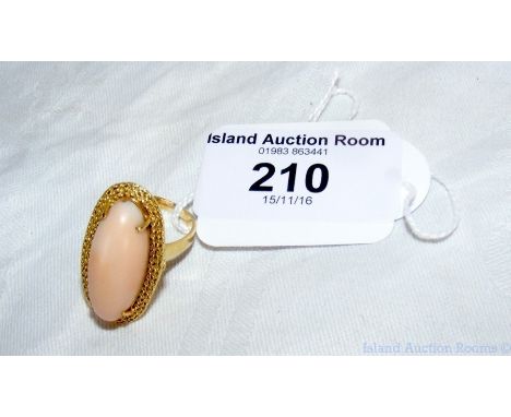 A large coral ring in 18ct gold setting