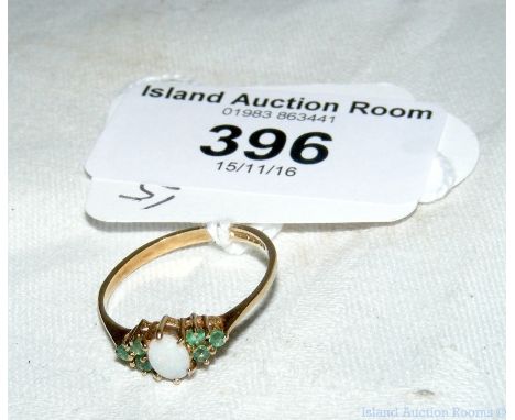 An emerald and opal ring in 9ct gold setting