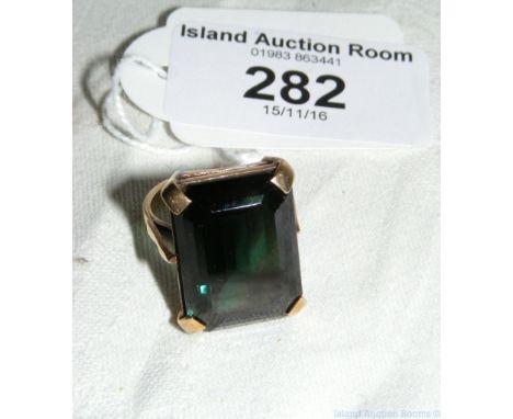 A green stone ring in gold setting
