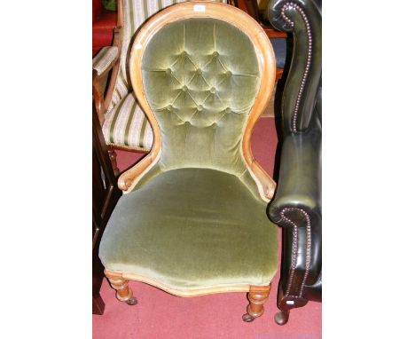 A button back nursing chair on turned supports
