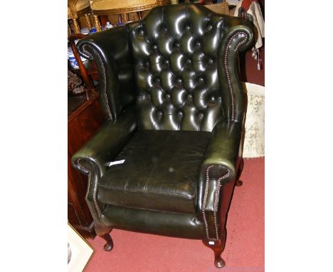 A pair of Georgian style button back wing easy chairs on cabriole supports
