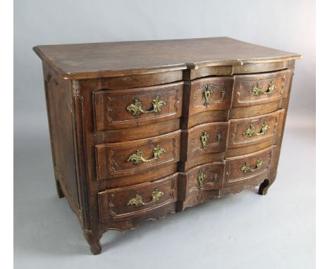 An 18th century French walnut serpentine commode, fitted three carved long drawers, on scroll feet, W.4ft 3in. D.2ft 4in. H.3