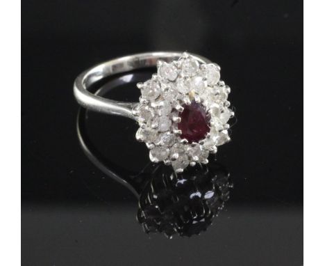 A 18ct white gold ruby and diamond oval cluster ring, size O.