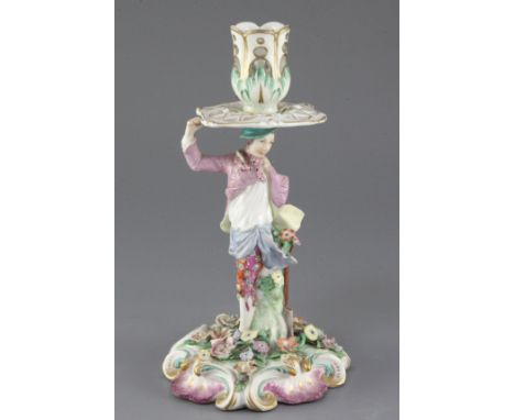 A Chelsea 'gardener' candlestick figure, c.1760-5, the figure holding a spade in his left hand and supporting a sconce and dr