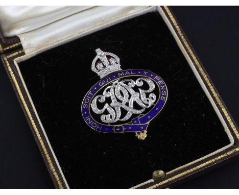 A mid 20th century gold, two colour enamel and diamond set Grenadier guards sweethearts brooch, in Goldsmiths & Silversmiths 