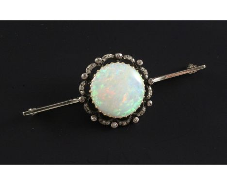 A Edwardian white gold, white opal and diamond set bar brooch, the central opal measuring 18mm in diameter, 2.5in.