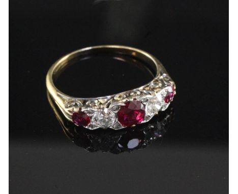 An early 20th century gold, ruby and diamond graduated five stone half hoop ring, size Q.