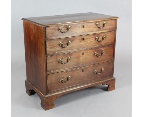 A George III mahogany chest, of four graduated long drawers, with original brass loop handles, on bracket feet, W.2ft 10in. D