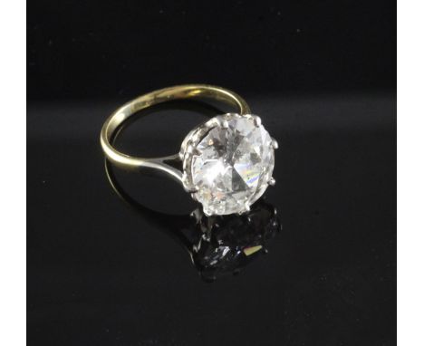 A gold, platinum and solitaire diamond ring, the old European cut stone weighing in excess of 4.00cts, with an approximately 