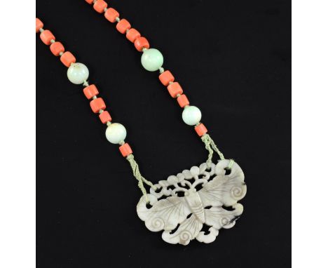 An early 20th century coral, jade and nephrite pendant necklace, the pendant, pierced and carved as a butterfly, 25.5in.