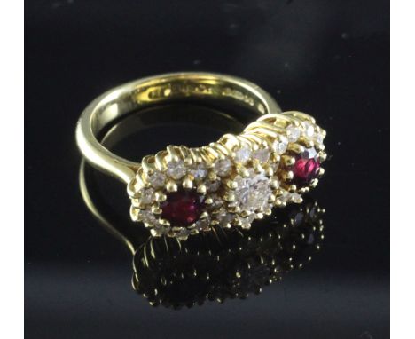 An 18ct gold ruby and diamond triple cluster ring, size K.