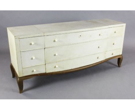 André Arbus (1903-1969) A fine and rare Art Deco serpentine commode, entirely covered with parchment, fitted nine drawers wit