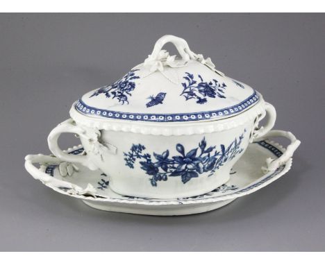 A Worcester lozenge shaped tureen cover and stand, c.1775, blue printed in the three flowers pattern, the stand with pine con