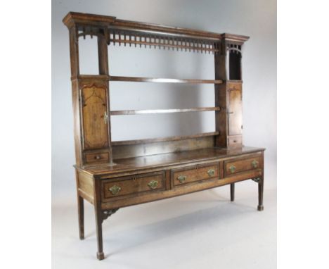 A mid 18th century mahogany banded oak dresser, with three shelf rack and three long drawers, on squared legs, W.6ft 11in. D.