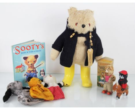 A Paddington Bear, with label to coat and yellow boots, c1980; a Japanese clockwork Cubby reading Bear with box; a Chad Valle