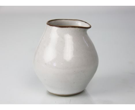 Dame Lucie Rie D.B.E (1902-1995) a stoneware pouring vessel, ovoid with pulled rim, glazed throughout in pale grey/white, the