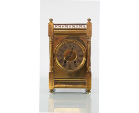 A late 19th Century gilt brass mantel clock, with pierced three quarter gallery above dial with Roman numeral chapter ring an