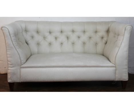 An Edwardian button back salon drop end settee, with foliate ivory upolstery on tapered square legs, 73cm H x 140cm W x 75cm 