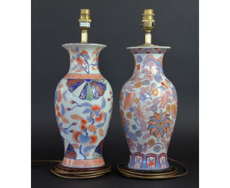 A near pair of imari pattern lamp bases, on turned wooden bases, 42cm high (2) 