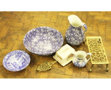 A 19th Century pierced brass teapot stand; a smaller brass stand; a blue and white wash jug and bowl; a blue and white Ashwor