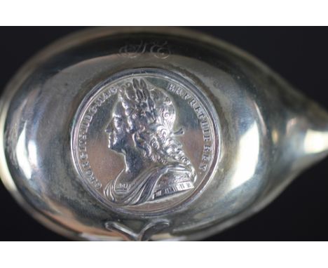 A George II silver toddy ladle, with spiral turned baleen handle and inset with a George II Coronation medal dated XI October