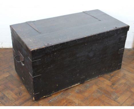 A late 19th Century iron bound stained pine trunk, hinged lid with recessed brass handles to the sides, 53cm H x 102cm W x 51