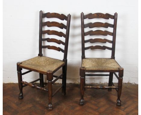 A set of four late 19th Century beech and ash ladder back dining chairs, with rush seats, on turned legs with pad feet, 99cm 
