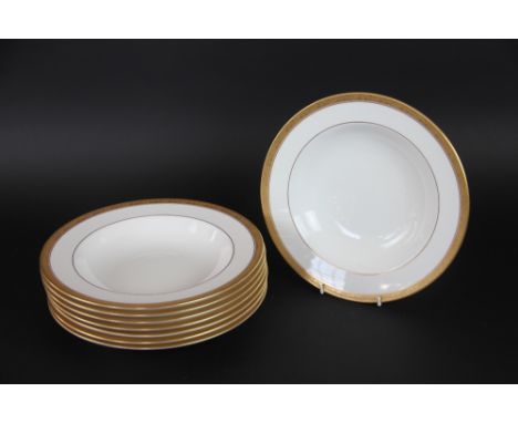 Eight Royal Worcester soup bowls with foliate gilt rims, 26.5cm