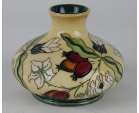 A Moorcroft squat ovoid vase c.1999, decorated with berries and white flowers against a yellow ground, impressed 'VT' and pai