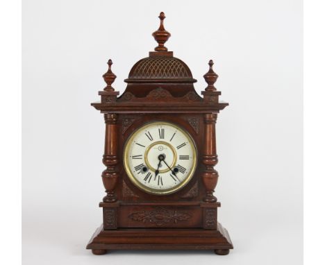 A walnut mantel clock, with painted Roman numeral dial signed Seikosha Tokyo, 54cm