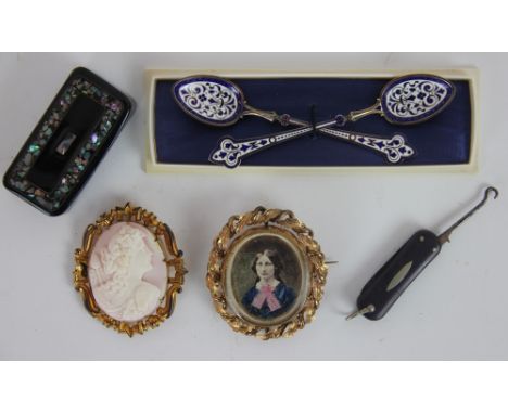A Victorian gold plated brooch, the oval frame with foliate openwork border inset with a tinted photograph of a Lady, the rev