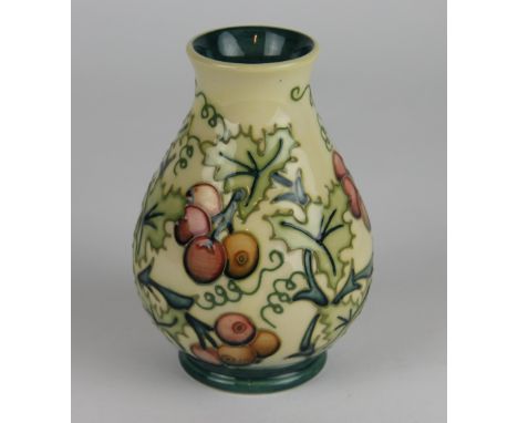 A Moorcroft Holly pattern vase c.1996, of tapering baluster form, decorated with foliage and berries against a graded yellow 