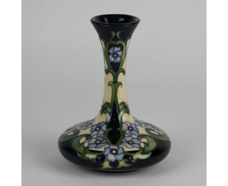 A Moorcroft vase by Rachel Bishop circa 2013, decorated with blue flowers and green scrolling foliage against a cobalt ground