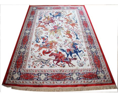 A Kashmir silk hunting scene carpet, worked with figures on horseback and animals against an ivory ground, the border with mu