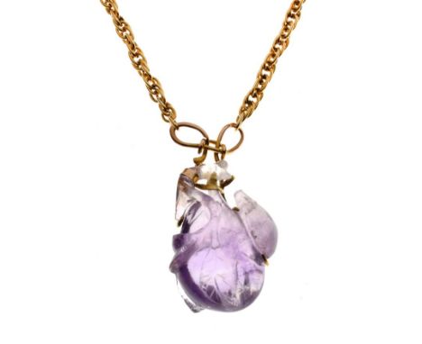 Carved amethyst quartz pendant with unmarked mount and chain   Condition: 